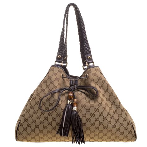 gucci small bag with braided botton and tassel|Gucci .